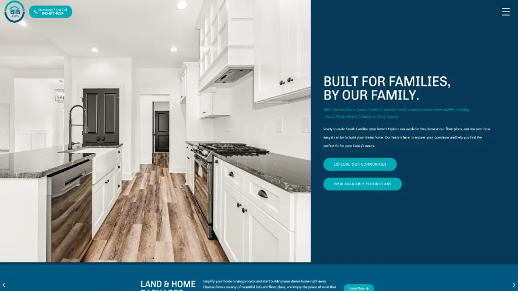 A modern kitchen featuring white cabinetry, dark wood accents, and stainless steel appliances. The open layout includes a preparation island and large windows that enhance the space's brightness, showcasing a clean design suitable for a home builder web design.