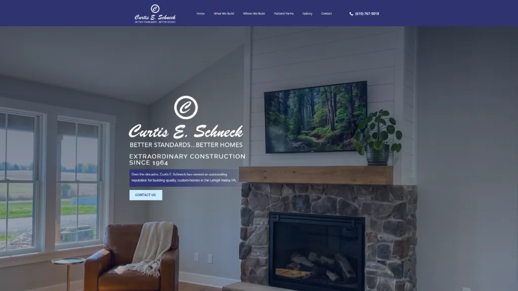 A modern living room featuring a stone fireplace and a wooden mantel. A television displaying a nature scene hangs above the mantel, and large windows provide a view of greenery outside. The design elements reflect a emphasis on responsive design.