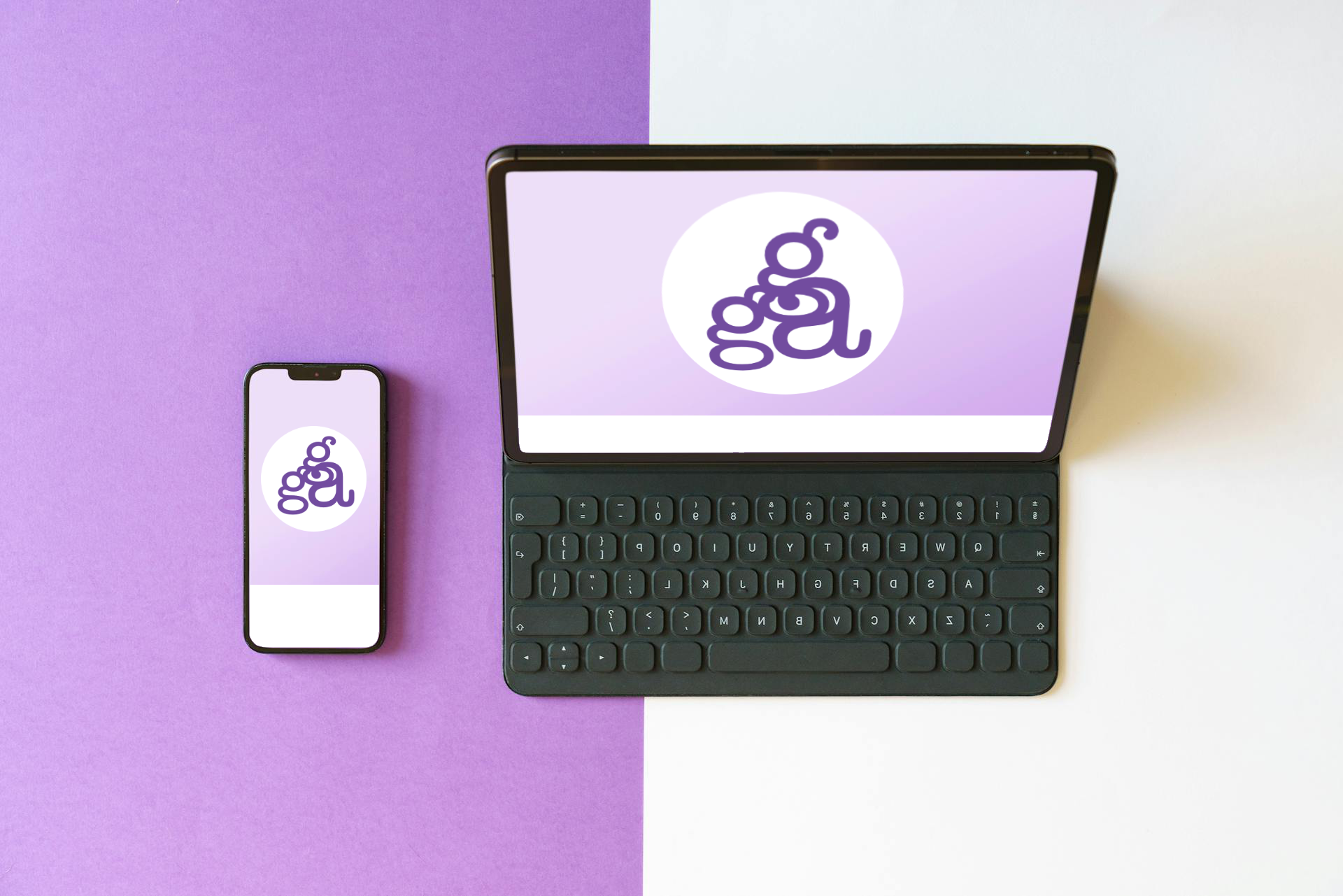 A tablet with a black keyboard and a smartphone are displayed on a purple and white background. Both screens show a logo in a circular format with a purple background, highlighting responsive web design.